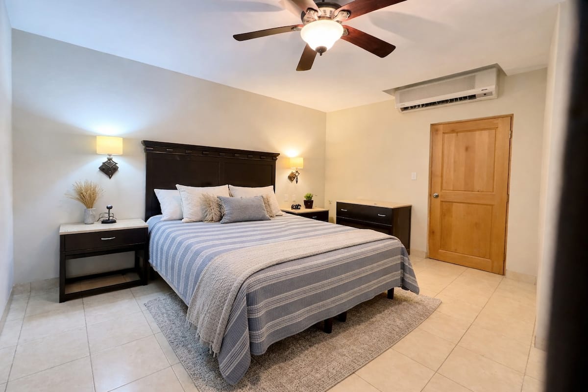 One of the penthouse bedrooms, bright and neatly made